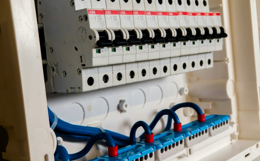A row of circuit breakers in an open distribution panel