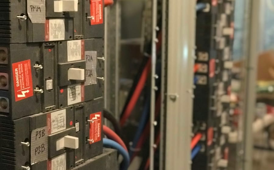 Older switchgear with worn labelling and mixed breakers